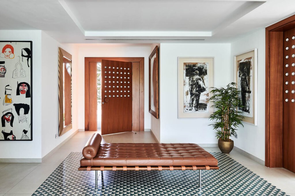 a leather daybed in a room with tiled floors and wood trim