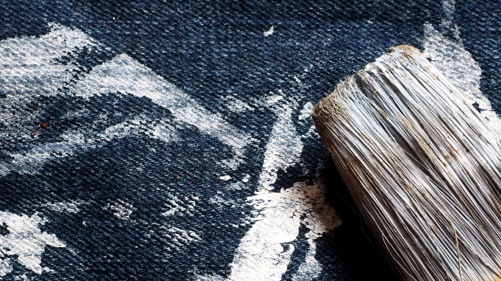 Paint brush on jeans with paint marks