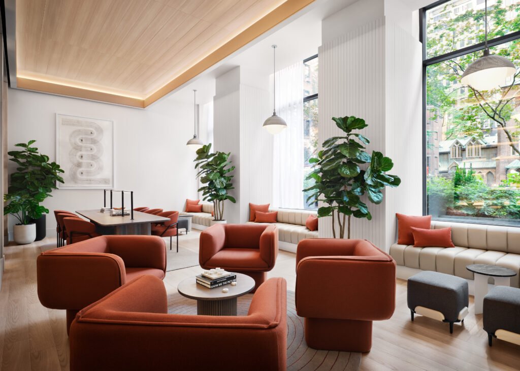 a building lobby with orange chairs