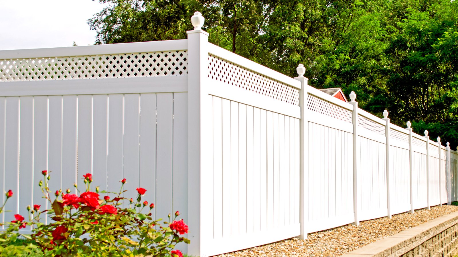 White ornate composite fence in back garden