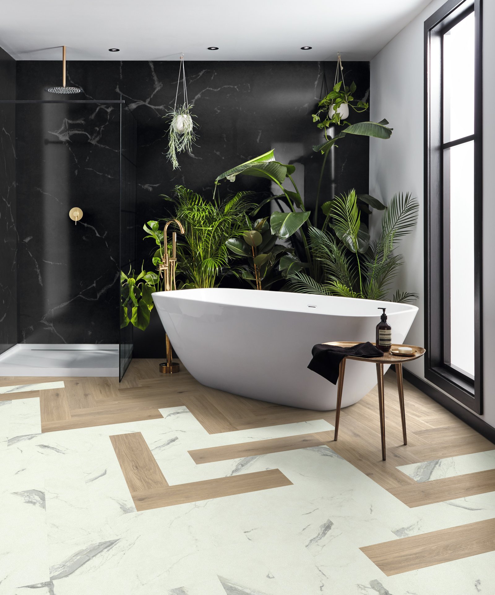 bathroom with freestanding white bath and a floor laid with white ceramic effect planks and wooden plans
