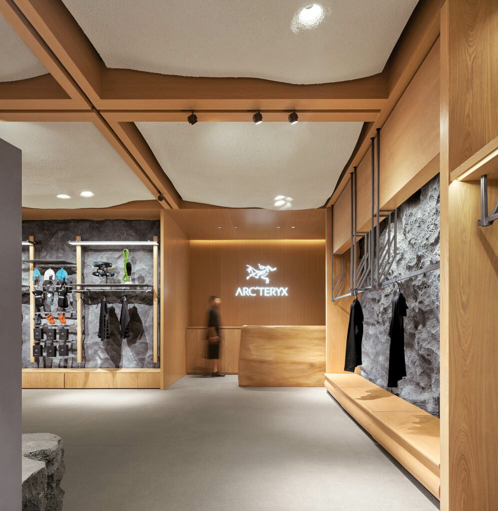 Arc'teryx's company logo glows behind the cash wrap counter