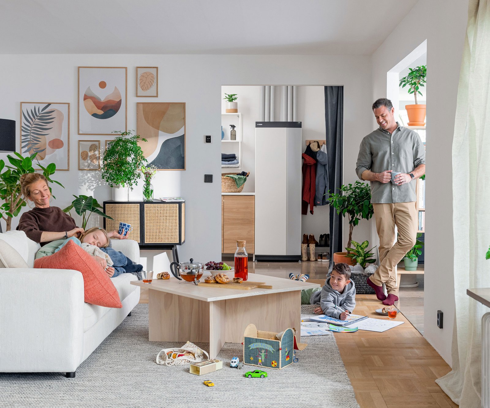 family in a living room that's heated by a heat pump