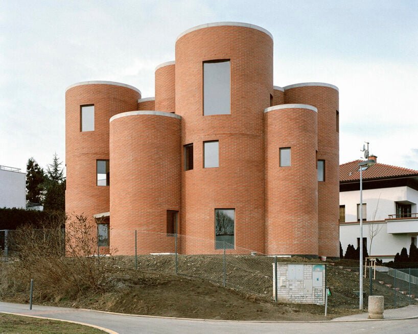 christian kerez's house okamura unfolds as a cluster of circular brick volumes in czechia