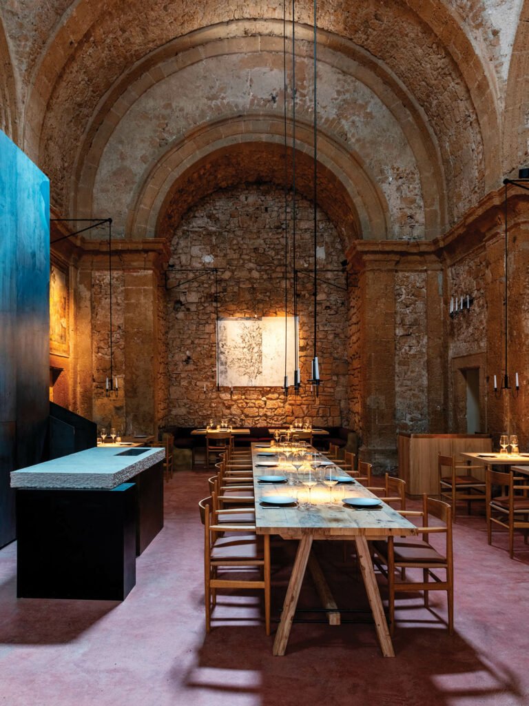 dining area with arched entryways and wooden table