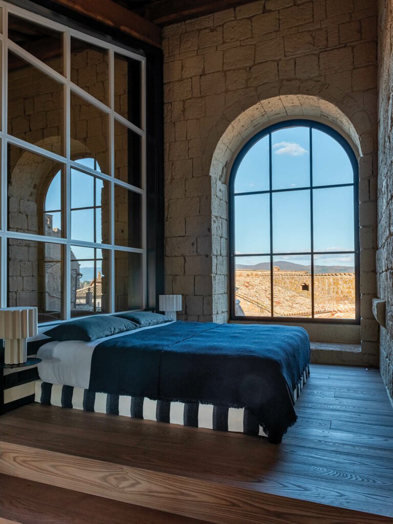 bedroom with arched windows and view to scenery