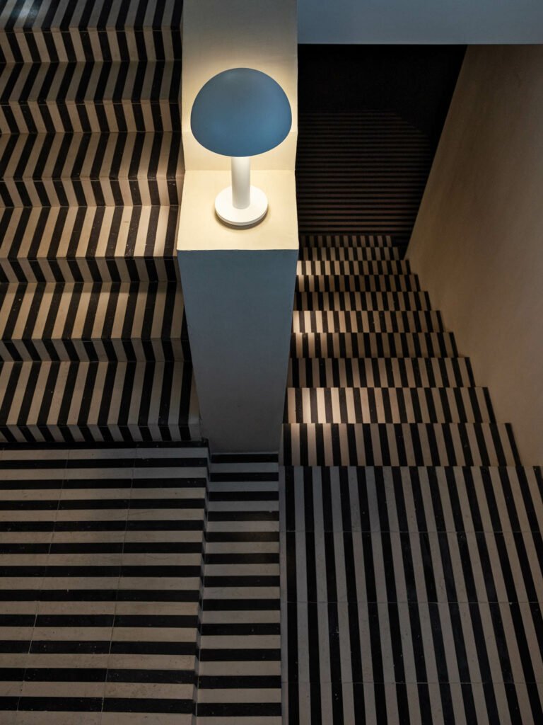 stairway with striped stairs and carpet