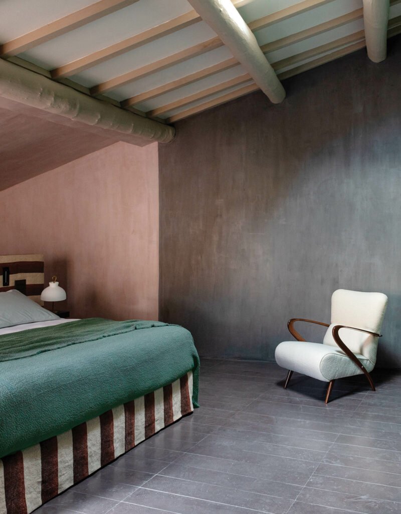 bedroom with grey walls and green bedspread