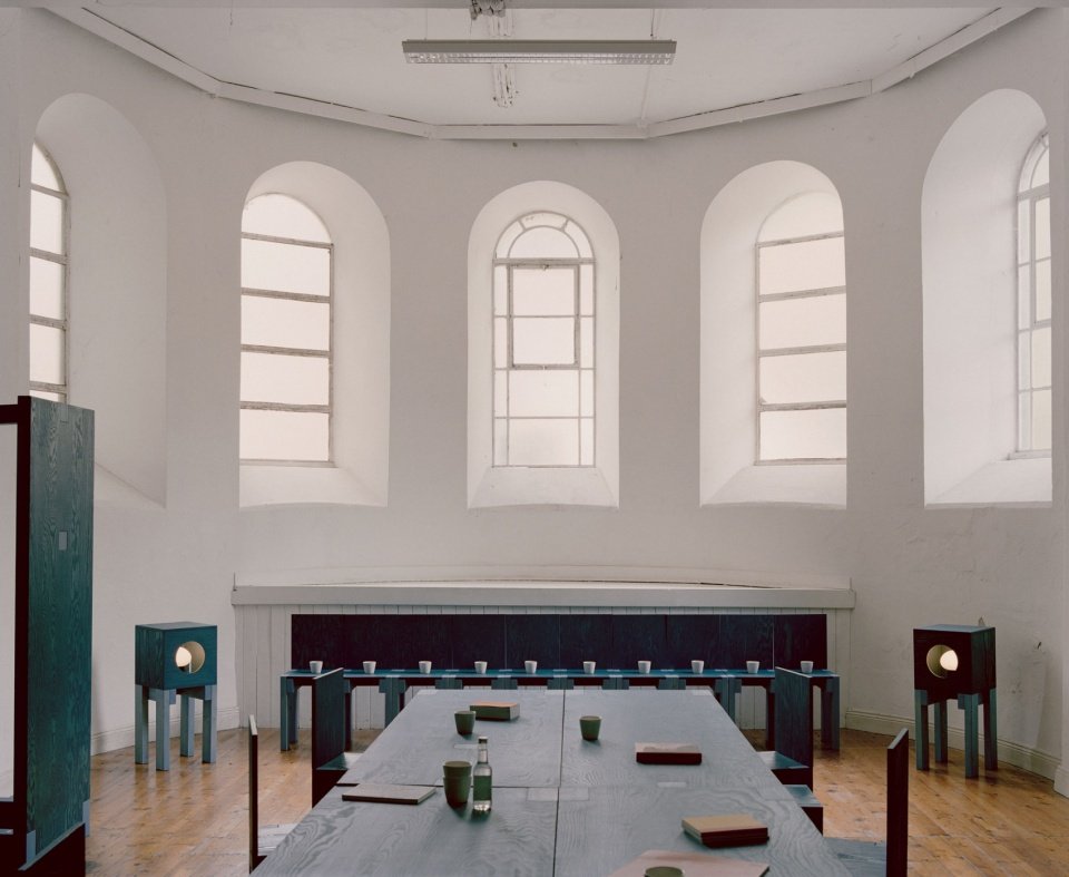 Public interior arranged around a long table