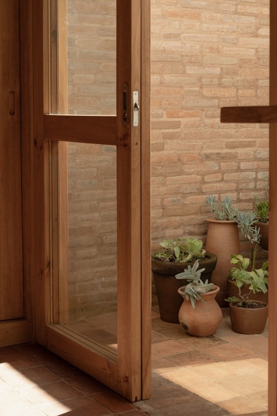 brick wall and timber-framed glazed door