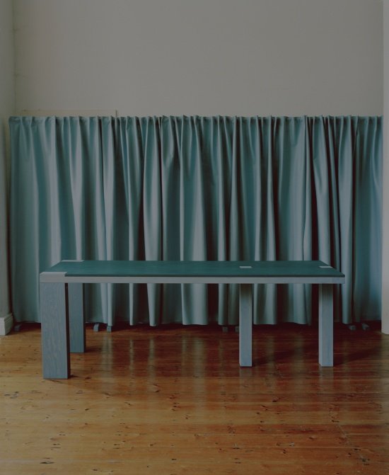 / Bench against a curtain backdrop