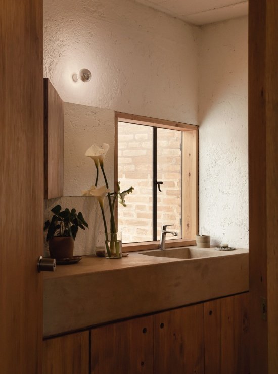 washbasin and timber cabinetry in the bathroom