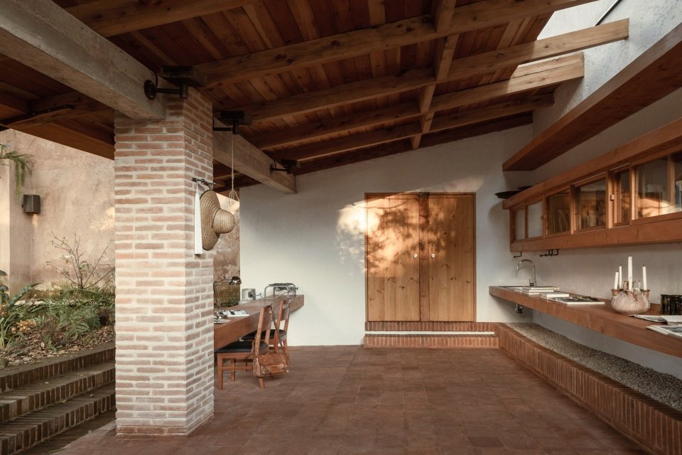 workshop beneath the timber roof and brick columns