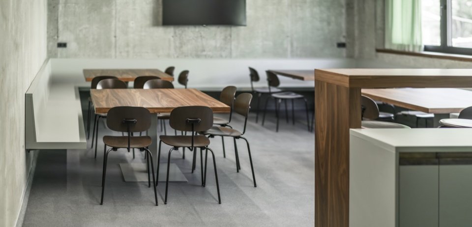 Common-room furniture and concrete walls