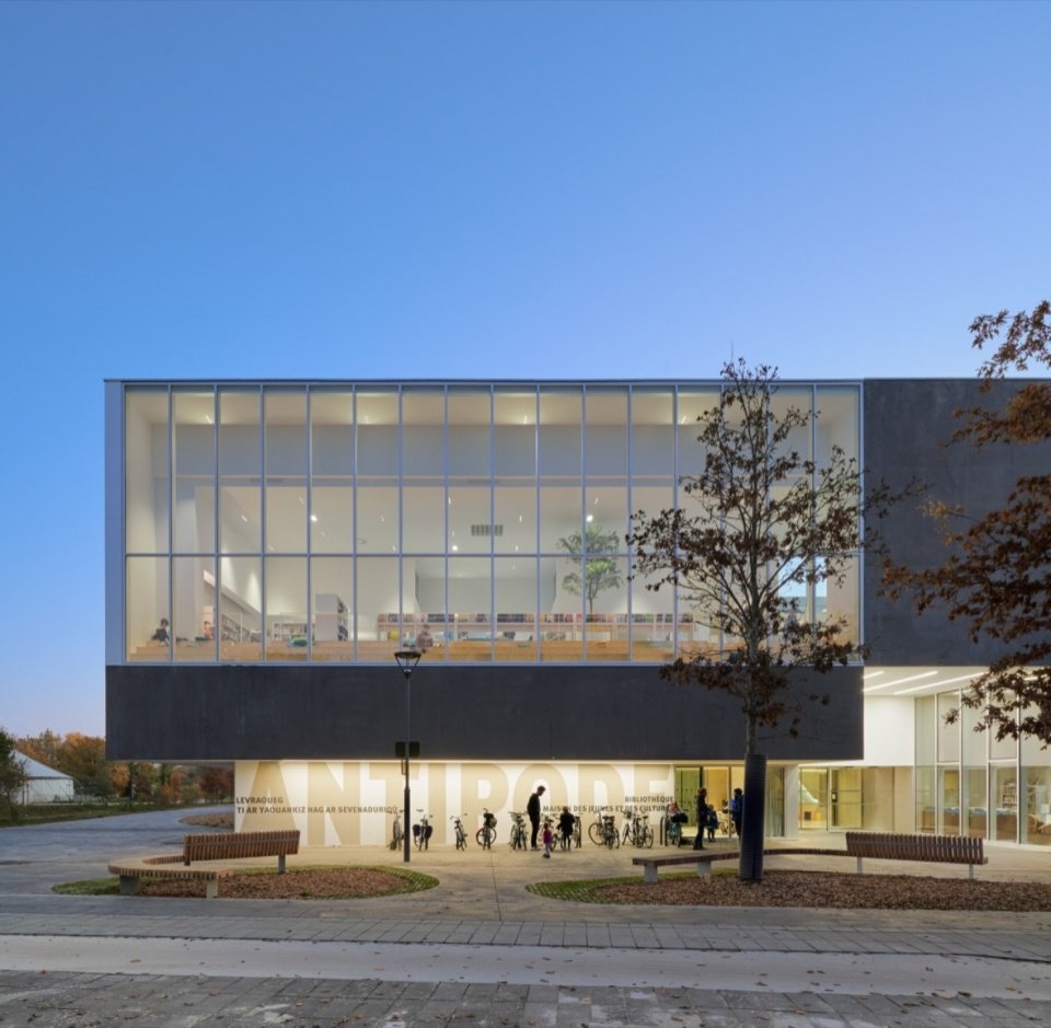 The glazed facade at dusk