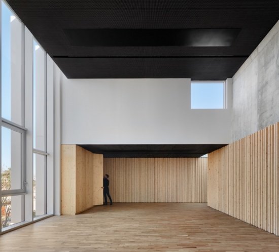 Activity space with timber lining and a dark ceiling