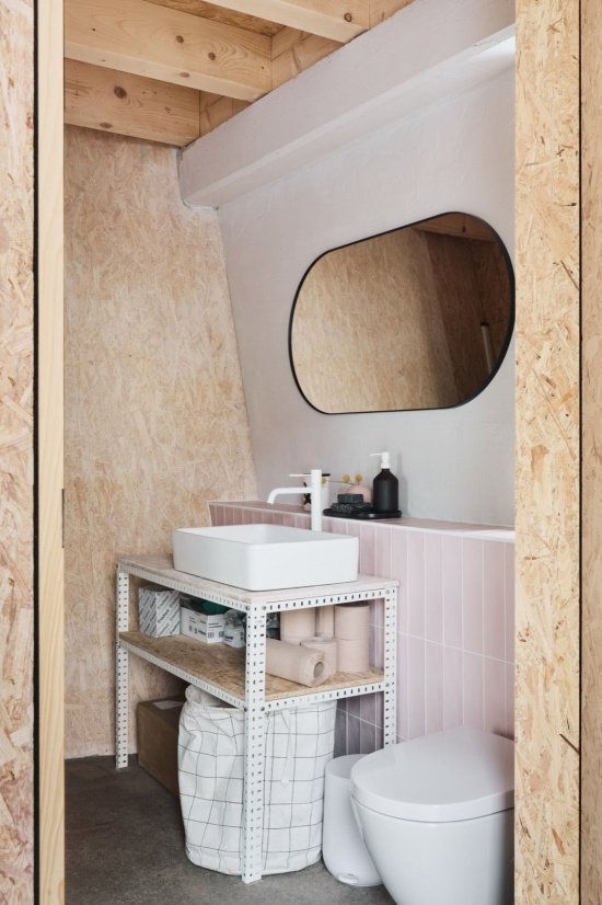 Compact bathroom within the timber structure